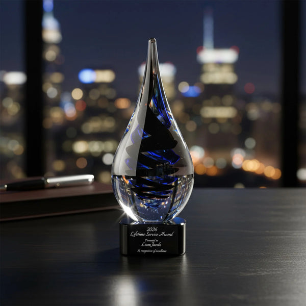 Crystal award with blue interior on a desk in front of a city skyline at night