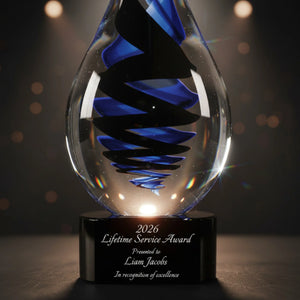 Glass award with blue and black design on a dark background
